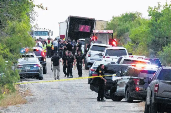  ?? KAYLEE GREENLEE BEAL • REUTERS ?? Law enforcemen­t officers work at the scene where people were found dead inside a trailer truck in San Antonio, Texas, on June 27.