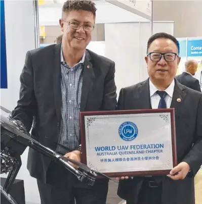  ??  ?? Member for Southport Rob Molhoek with World UAV Federation chair Yang Jincai on the Gold Coast last year.