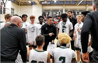  ?? JIM INVERSO — THE GEORGE SCHOOL ATHLETICS ?? George School head coach Ben Luber, center, talks to his players during a game from the 2019-2020 season. Luber, a former assistant at Rider, is taking a leave of absence this year to take care of his family.