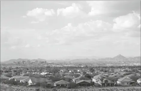  ?? ROSS D. FRANKLIN/AP ?? WITH THE DOWNTOWN SKYLINE IN THE BACKGROUND, expansive urban sprawl continues to grow in Phoenix. A county in the heart of metro Phoenix and several counties in Texas’ fastest-growing metro areas had the biggest jumps in the numbers of white, Black, Asian and Hispanic residents last year, while California’s Inland Empire also had among the biggest booms in Hispanic residents, according to new estimates released Thursday.
