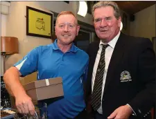  ??  ?? Seapoint Golf Club President Paddy Sullivan presents first prize in Category 1 of the President’s Prize to Eugene Holcroft.