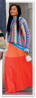  ?? ?? Ellie Delphine, above, wears a printed knit and orange maxi skirt in Paris