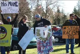  ?? Herald photo by Melissa Villeneuve ?? Supporters carry signs for the Stop Racism YQL rally held Sunday near Henderson Lake.