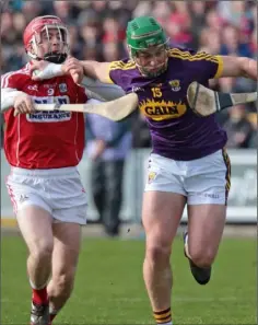  ??  ?? Wexford’s Conor McDonald holds off Daniel Kearney of Cork.