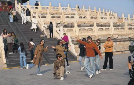  ?? PHOTOGRAPH: TATAN SYUFLANA/AP ?? ▲ TikToking tourists at the Temple of Heaven in Beijing. The app is hugely popular in the US and China