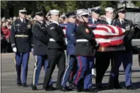  ?? DAVID J. PHILLIP — THE ASSOCIATED PRESS ?? The flag-draped casket of former President George H.W. Bush is carried by a joint services military honor guard to Special Air Mission 41 at Ellington Field during a departure ceremony Monday in Houston.