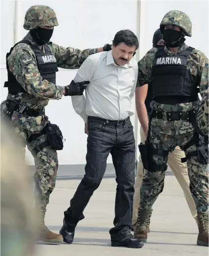  ?? ALFREDO ESTRELLA/ AFP/ GETTY IMAGES ?? Drug traffi cker Joaquin Guzman is escorted by marines as he is presented to the press Saturday in Mexico City. The Sinaloa cartel leader — wanted by U. S. and Mexican anti- drug agencies — was arrested at a resort in Mazatlan, northern Mexico.