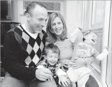  ?? RIC ERNST
POSTMEDIA NEWS FILE PHOTO ?? Ray Ferraro and wife Cammi Granato play with their two sons, then 10-month-old Reese and 3-year-old Riley (now 2 and 5) at their Vancouver home. As a TSN commentato­r, Ferrarro hasn’t seen much of his family in the past two weeks.