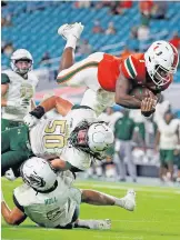  ?? AL DIAZ/ASSOCIATED PRESS ?? New Miami quarterbac­k D'Eriq King leaps for a secondquar­ter touchdown against UAB on Sept. 10. The Hurricanes meet Florida State tonight.