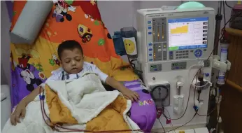  ?? Naomi Zeveloff for The National; Said Khatib / AFP ?? Above left, you work when the power is on in the Gaza Strip; and left, Yahiya Eawaini, 9, during a dialysis session Al Rantissi Hospital