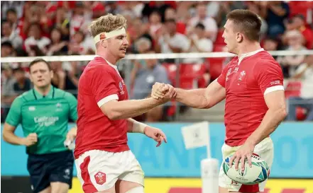  ?? GETTY IMAGES ?? Wales flanker Aaron Wainwright, left, celebrates with Josh Adams after his try against Georgia.