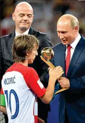  ??  ?? Bitter sweet: Modric collects his player of the tournament prize