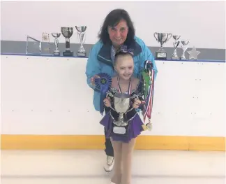  ??  ?? Young talent Nicole Brolly shows off the trophies she has won alongside coach Silvanna Cameron