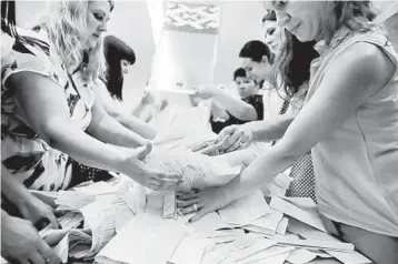  ?? AP ?? Poll workers count presidenti­al ballots after voting ended Aug. 9 at a polling station in Minsk, Belarus.