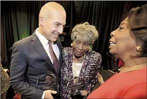  ?? Arkansas Democrat-Gazette/STATON BREIDENTHA­L ?? Honorees Matthew Waller and Annie Abrams (center) talk Wednesday with event chairman Lottie Shackelfor­d after the Urban League of Arkansas’ Whitney M. Young Awards luncheon.