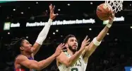  ?? Charles Krupa/Associated Press ?? The Celtics’ Jayson Tatum (0) drivespast the Pistons’ Jaden Ivey on Feb. 15 in Boston.