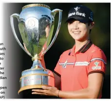  ??  ?? Sung Hyun Park, of South Korea, poses for a photo with the trophy after winning the 2017 Canadian Pacific Women's Open in Ottawa on Sunday. (AP)