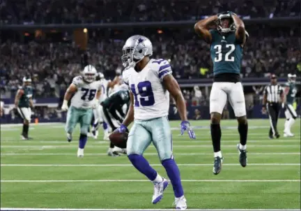  ?? THE ASSOCIATED PRESS ?? Cowboys wide receiver Amari Cooper (19) scores a 15-yard touchdown against the Eagles in overtime of Sunday’s game in Arlington, Texas.