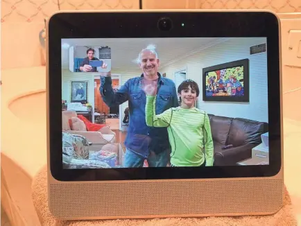  ?? JEFFERSON GRAHAM/USA TODAY ?? USA TODAY’s Edward C. Baig and son Sam wave to Jefferson Graham during a video chat on the Facebook Portal device.