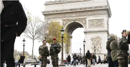  ?? — AP ?? PARIS: French soldiers patrol the Arch of Triumph on the Champs Elysees avenue of Paris, in France yesterday.