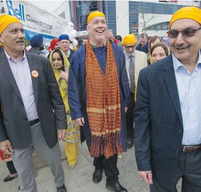  ?? JASON PAYNE / POSTMEDIA NEWS ?? British Columbia NDP party leader John Horgan, here at the annual Surrey Vaisakhi Parade in Surrey, B.C. is at odds with Alberta’s NDP Premier Rachel Notley on pipeline policy and expansion of oil extraction from the oilsands.