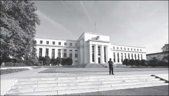  ??  ?? A police officer keeps watch in front of the US Federal Reserve building in Washington.