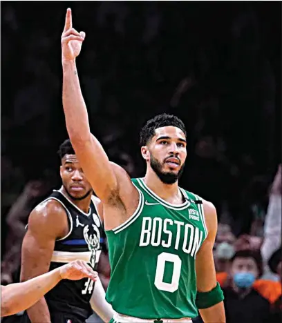  ?? CHARLES KRUPA / AP ?? Boston Celtics forward Jayson Tatum (0) celebrates after a basket against the Milwaukee Bucks in the first half of Game 2 of their Eastern Conference semifinal on Tuesday in Boston.