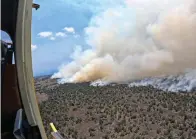  ?? Hawaii Department of Land and Natural Resources via AP ?? This photo provided by the Hawaii Department of Land and Natural Resources shows a large wildfire in a rural area of Hawaii’s Big Island that is not threatenin­g any homes, but high winds and extremely dry conditions are making it difficult for crews to contain the blaze.