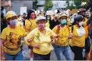  ?? ASSOCIATED PRESS FILE ?? Norma Lewis holds a flower while forming a “wall of moms” during a Black Lives Matter protest in Portland, Ore., in July.