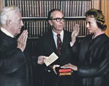  ?? Associated Press ?? SANDRA DAY O’CONNOR is sworn in as a Supreme Court justice by Chief Justice Warren Burger, left, on Sept. 25, 1981. With O’Connor is her husband, John. She served on the Supreme Court for 24 years.