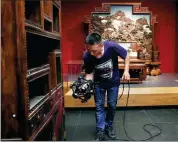  ?? JIANG DONG / CHINA DAILY ?? A staff member of the Palace Museum takes measuremen­ts of a piece of royal furniture from the Qing Dynasty (1644-1911) on Friday.