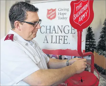  ?? JOURNAL PIONEER FILE PHOTO ?? Capt. Neil Abbott of the Summerside Salvation Army Corps secures a Christmas kettle to its stand. The 2017 Christmas Kettle Campaign began on Nov. 17 and ran until Dec. 23.