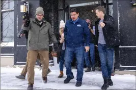  ?? ANDREW HARNIK — THE ASSOCIATED PRESS ?? Republican presidenti­al candidate Florida Gov. Ron DeSantis, center, accompanie­d by his press secretary Bryan Griffin, right, departs after speaking at a Northside Conservati­ves Club Meeting at The District in Ankeny, Iowa, on Friday.