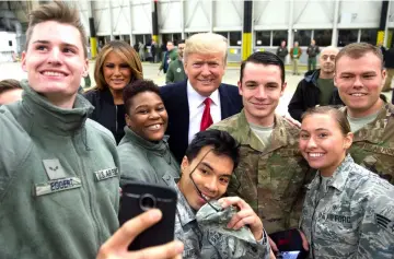  ?? — AFP photo ?? Trump and Melania greet members of the US military during a stop at Ramstein Air Base in Germany.