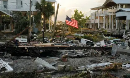  ?? Photograph: Cheney Orr/Reuters ?? An American flag is seen amidst the wreckage of Darlene Powell’s home after the arrival of Hurricane Idalia in Horseshoe Beach, Florida, on Thursday.