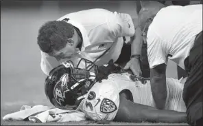  ?? AP/NICK WASS ?? Baltimore Ravens running back Kenneth Dixon (Strong) is tended to by trainers after suffering a knee sprain during the first half of Saturday’s exhibition game against the Detroit Lions in Baltimore. Dixon was trying to push forward on a goal-line...