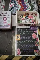  ?? ?? Reusable sanitary towels, feminist stickers and a domestic violence helpline on display at one of the market stalls