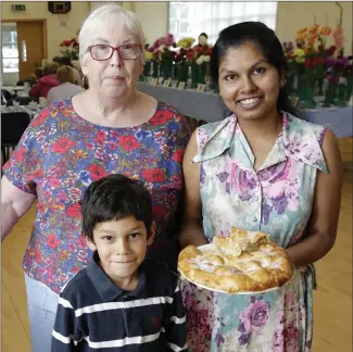  ??  ?? Show secretary Mary Wall with Patrick and Protima Mooney and some of Protima’s home baking.