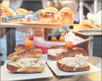  ??  ?? Dungeness crab on a pretzel roll is offered by chefs from Levy, the new concession­aire at Levi’s Stadium.