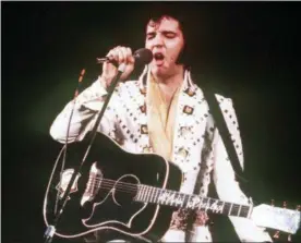  ?? THE ASSOCIATED PRESS ?? In this 1973file photo, Elvis Presley sings during a concert. A private jet once owned by Elvis Presley that has sat on a runway in New Mexico for nearly four decades is back on the auction block. The online auction site IronPlanet announced this week...