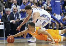  ?? JAMES CRISP — THE ASSOCIATED PRESS ?? Kentucky’s Reid Travis, top, and Tennessee’s Grant Williams chase down a loose ball during the first half of an NCAA college basketball game in Lexington, Ky. Saturday.