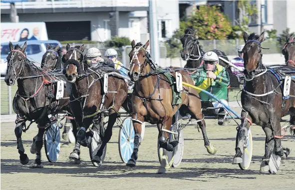  ??  ?? Storming home . . . Armstrong and driver Matthew Williamson (blue and yellow colours, right) sprint along the passing lane to win race 2 at Forbury