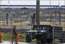  ?? Sam Owens/The San Antonio Express-News via AP ?? Texas Department of Public Safety officers guard an entrance to Shelby Park on Jan. 11 in Eagle Pass, Texas. A federal appeals court on Tuesday refused to lift an order that blocks Texas from arresting and deporting migrants suspected of illegally crossing the border.