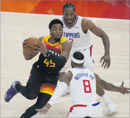  ?? PHOTOS BY RICK BOWMER — THE ASSOCIATED PRESS ?? The Clippers’ Kawhi Leonard (2) and Marcus Morris Sr. try to stop Utah’s Donovan Mitchell, who scored 45 points in the Jazz’s Game 1 victory.