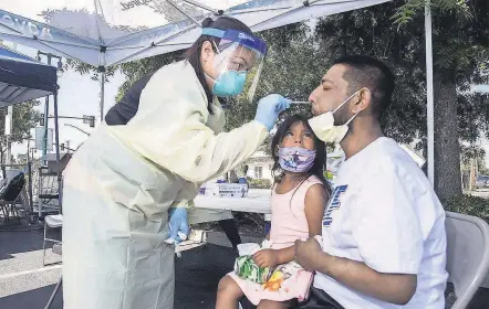  ?? CLIFFORD OTO/ USA TODAY NETWORK ?? Katrina Nguyen tests Juan Cisneros, with daughter Jaylah, 5, in Lodi, Calif.