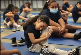  ?? AL SEIB — LOS ANGELES TIMES ?? Children participat­e in yoga postures, deep breathing and meditation techniques.