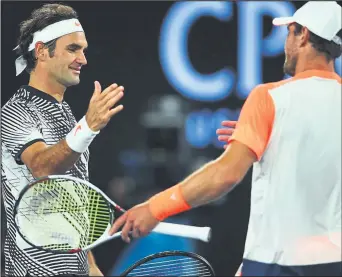  ??  ?? Shake on it...Roger Federer commiserat­es with Mischa Zverev after his demolition of the German