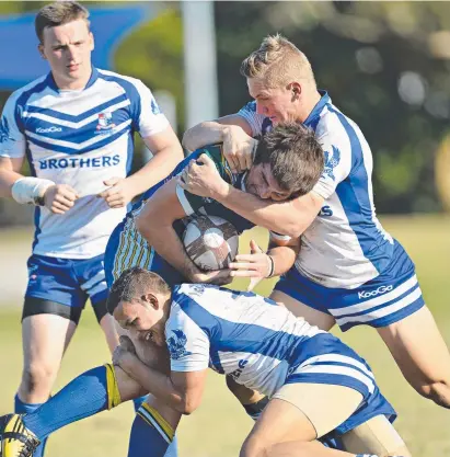  ?? HANDY TACKLER: Maroons rookie Coen Hess ( centre) in action for Ignatius Park College during his school footy days ??