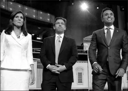  ?? WILFREDO LEE / ASSOCIATED PRESS ?? Republican presidenti­al candidates Nikki Haley, left, Florida Gov. Ron Desantis and Vivek Ramaswamy take the stage Wednesday before the start of a Republican presidenti­al primary debate at the Adrienne Arsht Center for the Performing Arts of Miami-dade County in Miami.