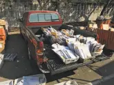  ??  ?? A pickup truck was used as makeshift storage at the neighborho­od post office in Santa Rosa.